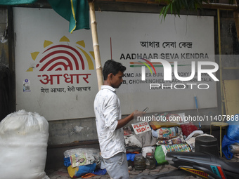 A person is passing next to Aadhar Seva Kendra in Kolkata, India, on July 14, 2024. (