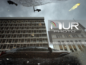 Houses are being reflected in a puddle of rainwater after a heavy rain in Kolkata, India, on July 14, 2024. (