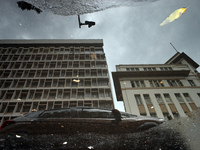 Houses are being reflected in a puddle of rainwater after a heavy rain in Kolkata, India, on July 14, 2024. (