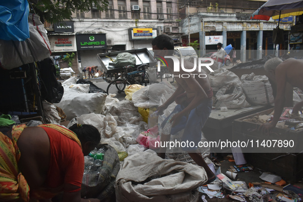 People are working in a plastic recycling hub in Kolkata, India, on July 14, 2024. 