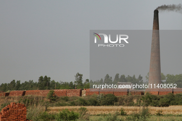 Smoke is rising from a brick factory in Najibabad, Uttar Pradesh, India, on April 19, 2024. 