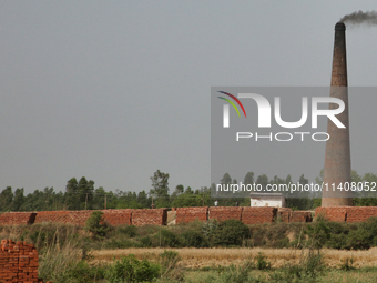 Smoke is rising from a brick factory in Najibabad, Uttar Pradesh, India, on April 19, 2024. (