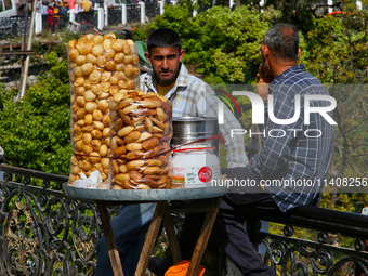 Men are selling snacks along Mall Road in Mussoorie, Uttarakhand, India, on April 18, 2024. (