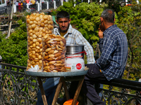 Men are selling snacks along Mall Road in Mussoorie, Uttarakhand, India, on April 18, 2024. (