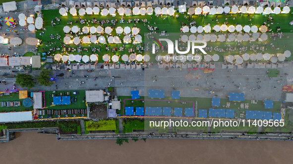 People are eating food at the night market on Nanbin Road in Chongqing, China, on July 14, 2024. It is reported that with the arrival of the...