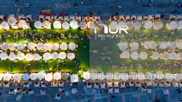 People are eating food at the night market on Nanbin Road in Chongqing, China, on July 14, 2024. It is reported that with the arrival of the...