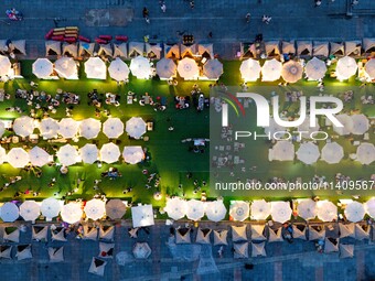 People are eating food at the night market on Nanbin Road in Chongqing, China, on July 14, 2024. It is reported that with the arrival of the...