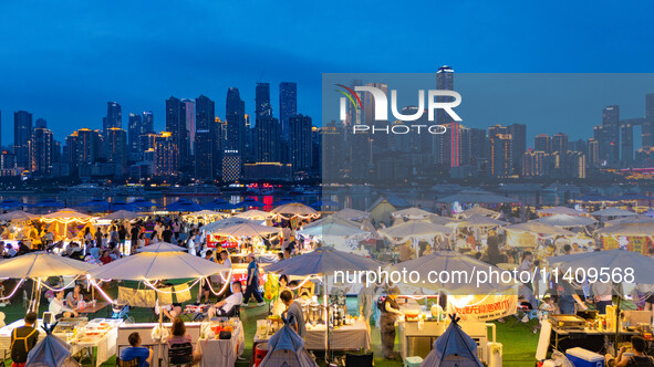 People are eating food at the night market on Nanbin Road in Chongqing, China, on July 14, 2024. It is reported that with the arrival of the...