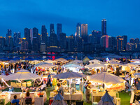 People are eating food at the night market on Nanbin Road in Chongqing, China, on July 14, 2024. It is reported that with the arrival of the...