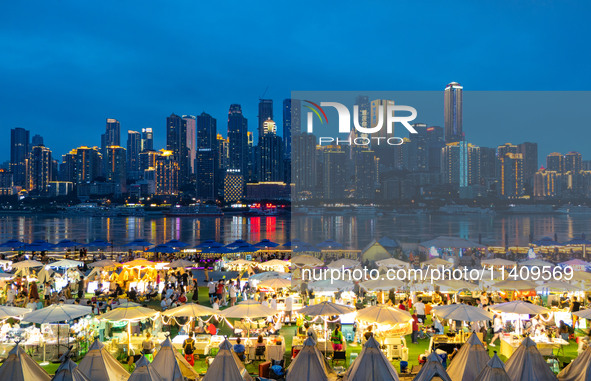 People are eating food at the night market on Nanbin Road in Chongqing, China, on July 14, 2024. It is reported that with the arrival of the...