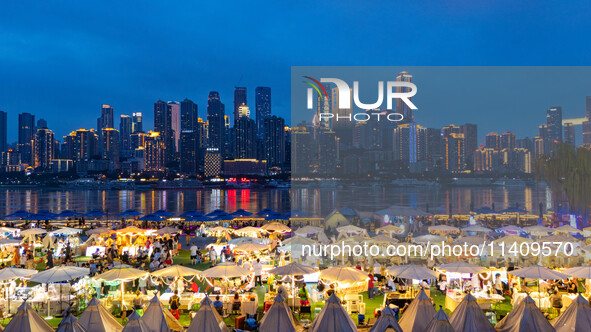 People are eating food at the night market on Nanbin Road in Chongqing, China, on July 14, 2024. It is reported that with the arrival of the...