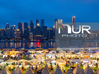 People are eating food at the night market on Nanbin Road in Chongqing, China, on July 14, 2024. It is reported that with the arrival of the...