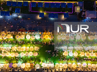 People are eating food at the night market on Nanbin Road in Chongqing, China, on July 14, 2024. It is reported that with the arrival of the...