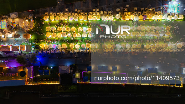 People are eating food at the night market on Nanbin Road in Chongqing, China, on July 14, 2024. It is reported that with the arrival of the...