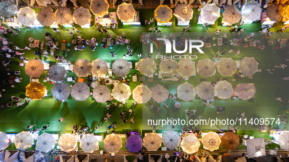 People are eating food at the night market on Nanbin Road in Chongqing, China, on July 14, 2024. It is reported that with the arrival of the...