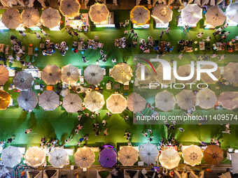 People are eating food at the night market on Nanbin Road in Chongqing, China, on July 14, 2024. It is reported that with the arrival of the...