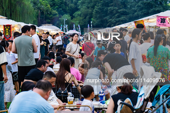 People are eating food at the night market on Nanbin Road in Chongqing, China, on July 14, 2024. It is reported that with the arrival of the...