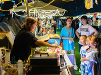 People are eating food at the night market on Nanbin Road in Chongqing, China, on July 14, 2024. It is reported that with the arrival of the...