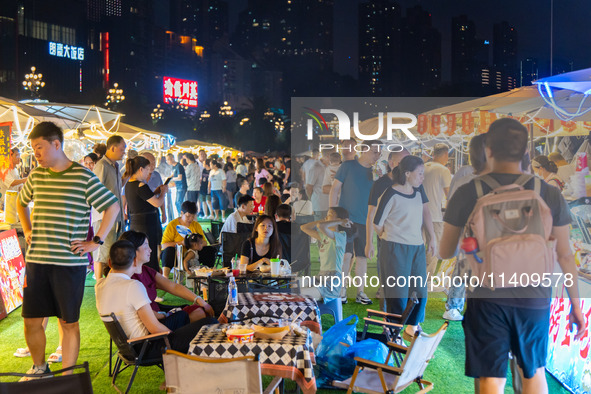 People are eating food at the night market on Nanbin Road in Chongqing, China, on July 14, 2024. It is reported that with the arrival of the...