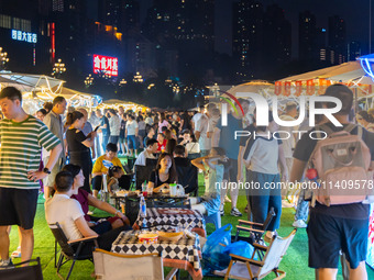 People are eating food at the night market on Nanbin Road in Chongqing, China, on July 14, 2024. It is reported that with the arrival of the...