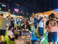 People are eating food at the night market on Nanbin Road in Chongqing, China, on July 14, 2024. It is reported that with the arrival of the...