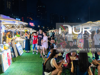 People are eating food at the night market on Nanbin Road in Chongqing, China, on July 14, 2024. It is reported that with the arrival of the...