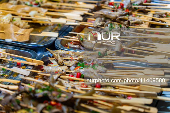 People are eating food at the night market on Nanbin Road in Chongqing, China, on July 14, 2024. It is reported that with the arrival of the...