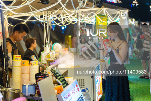 People are eating food at the night market on Nanbin Road in Chongqing, China, on July 14, 2024. It is reported that with the arrival of the...