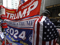 Supporters  of former President Donald Trump’s gather with flags in front of his Fifth Avenue residence on July 14,2024 in New York City, US...