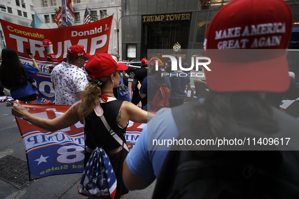 Supporters  of former President Donald Trump’s gather with flags in front of his Fifth Avenue residence on July 14,2024 in New York City, US...