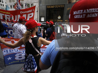 Supporters  of former President Donald Trump’s gather with flags in front of his Fifth Avenue residence on July 14,2024 in New York City, US...