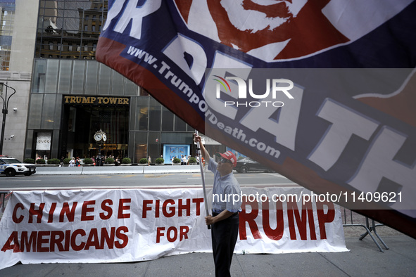 Supporters  of former President Donald Trump’s gather with flags in front of his Fifth Avenue residence on July 14,2024 in New York City, US...