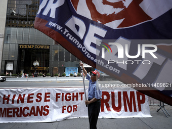 Supporters  of former President Donald Trump’s gather with flags in front of his Fifth Avenue residence on July 14,2024 in New York City, US...