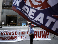 Supporters  of former President Donald Trump’s gather with flags in front of his Fifth Avenue residence on July 14,2024 in New York City, US...