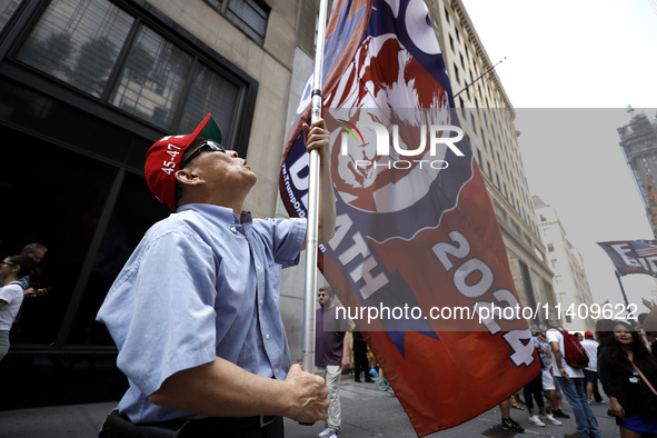 Supporters  of former President Donald Trump’s gather with flags in front of his Fifth Avenue residence on July 14,2024 in New York City, US...