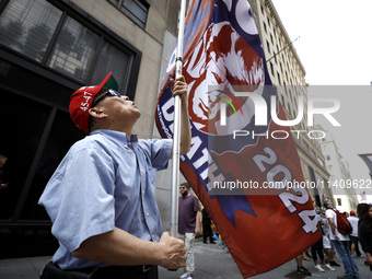 Supporters  of former President Donald Trump’s gather with flags in front of his Fifth Avenue residence on July 14,2024 in New York City, US...