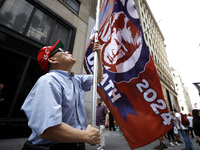 Supporters  of former President Donald Trump’s gather with flags in front of his Fifth Avenue residence on July 14,2024 in New York City, US...