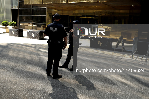 Police stand watch as supporters  of former President Donald Trump’s gather with flags in front of his Fifth Avenue residence on July 14,202...