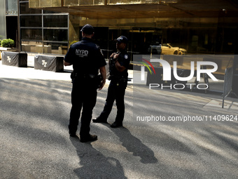 Police stand watch as supporters  of former President Donald Trump’s gather with flags in front of his Fifth Avenue residence on July 14,202...