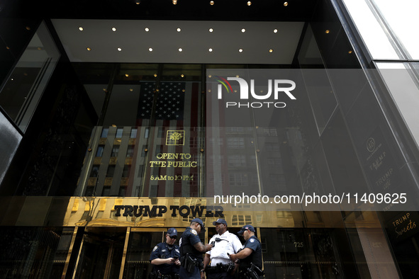 Police stand watch as supporters  of former President Donald Trump’s gather with flags in front of his Fifth Avenue residence on July 14,202...