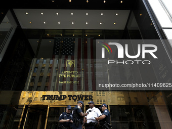 Police stand watch as supporters  of former President Donald Trump’s gather with flags in front of his Fifth Avenue residence on July 14,202...