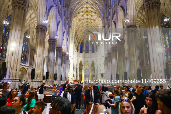 Tourists inside St Patrick's Cathedral in New York City, United States of America on July 5th, 2024. 