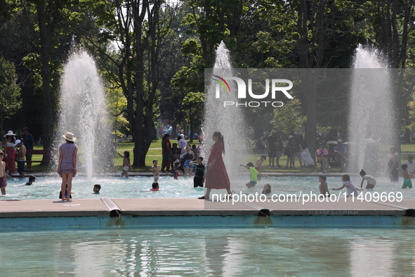 People are cooling off in the water on Centre Island on a hot day in Toronto, Ontario, Canada, on July 13, 2024. 