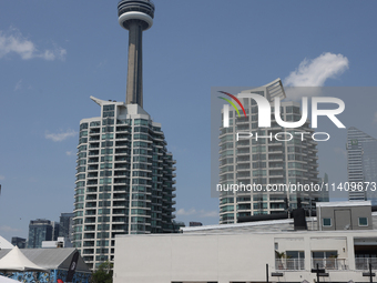 People are cooling off during a hot summer afternoon as they walk amongst water vapor being sprayed from the ground in Toronto, Ontario, Can...