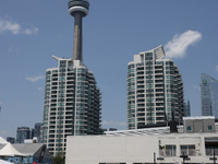 People are cooling off during a hot summer afternoon as they walk amongst water vapor being sprayed from the ground in Toronto, Ontario, Can...