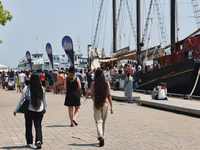 People are walking along the boardwalk at Harbourfront in Toronto, Ontario, Canada, on July 13, 2024. (