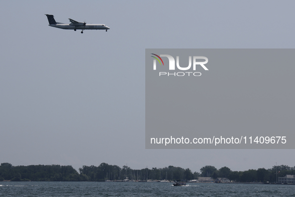 A Porter Airlines airplane is flying over Lake Ontario in Toronto, Ontario, Canada, on July 13, 2024. 