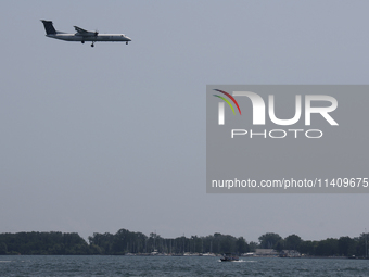 A Porter Airlines airplane is flying over Lake Ontario in Toronto, Ontario, Canada, on July 13, 2024. (