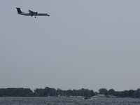 A Porter Airlines airplane is flying over Lake Ontario in Toronto, Ontario, Canada, on July 13, 2024. (