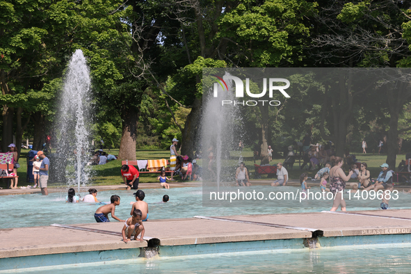 People are cooling off in the water on Centre Island on a hot day in Toronto, Ontario, Canada, on July 13, 2024. 